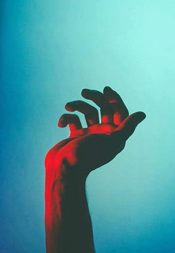 Red Hand Against Blue Background Cinematic Imagery