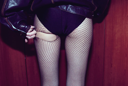 Girl in Leather Jacket Ripping Fishnet Stockings